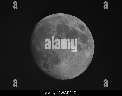 Waxing Gibbous Moon photographed on 22 March 2024 above London, UK. Single image of the lunar disk in clear evening sky with the crater Tycho prominent in the Southern Highlands area (lower centre) Stock Photo