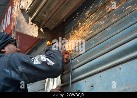 Closeup of a man cutting Steel Plate with a circular grinder cutter Stock Photo