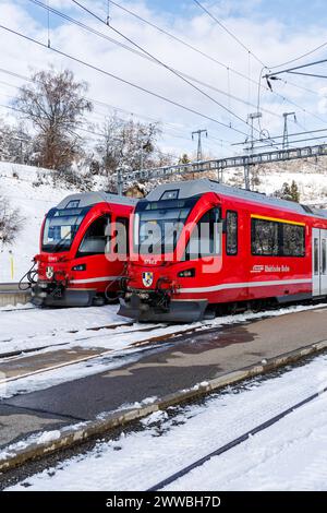 Filisur, Switzerland - January 10, 2024: Rhaetian Railway passenger trains on Albula line by Stadler Rail at train station in Filisur, Switzerland. Stock Photo