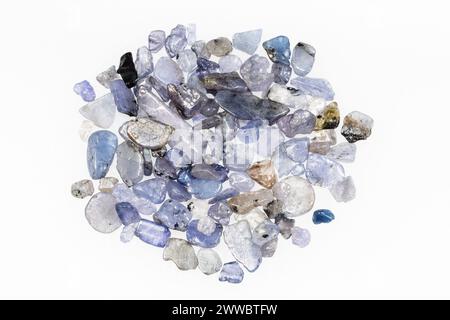 close up of sample of natural stone from geological collection - many unpolished tanzanite gemstones on white background from Tanzania Stock Photo