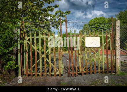 Rusted Gates partially ajar but chained together with a padlock to secure them. Stock Photo
