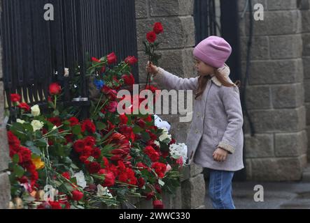 Minsk. 23rd Mar, 2024. A child lays flowers to commemorate victims of Moscow terrorist attack in front of the Russian Embassy in Minsk, Belarus on March 23, 2024. The death toll from Friday's terrorist attack has risen to 143 after gunmen stormed a concert hall in Moscow, Margarita Simonyan, editor-in-chief of RT broadcast said Saturday. Credit: Henadz Zhinkov/Xinhua/Alamy Live News Stock Photo