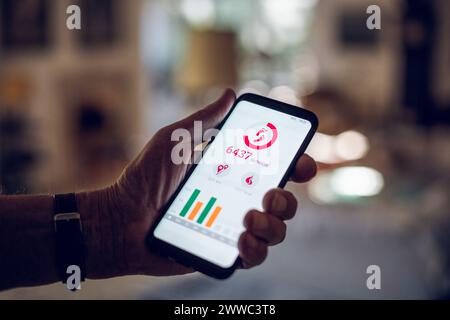 Senior holding smartphone, using fitness app Stock Photo