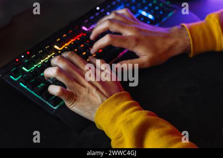 Hands of man typing on illuminated keyboard Stock Photo