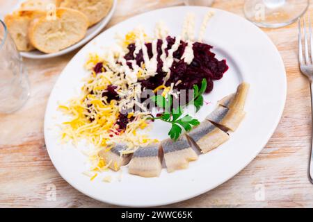 Beetroot served with cheese and pickled mackerel Stock Photo