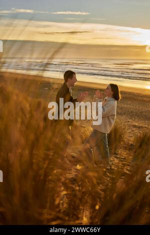 Happy couple spending leisure time at ocean beach Stock Photo