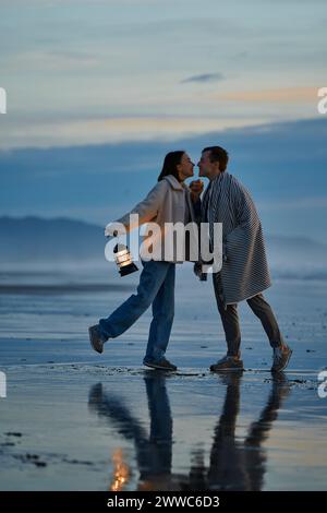 Affectionate couple dancing together at beach Stock Photo