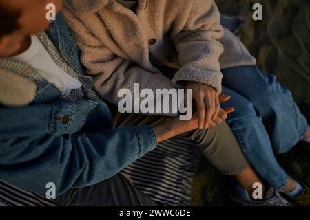 Young man and woman holding hands Stock Photo