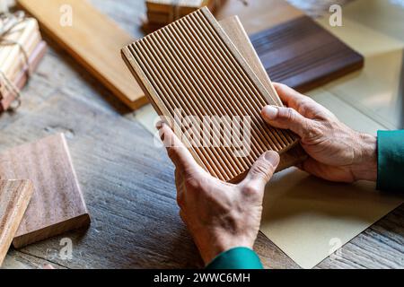 Hands of businessman holding wooden samples in office Stock Photo