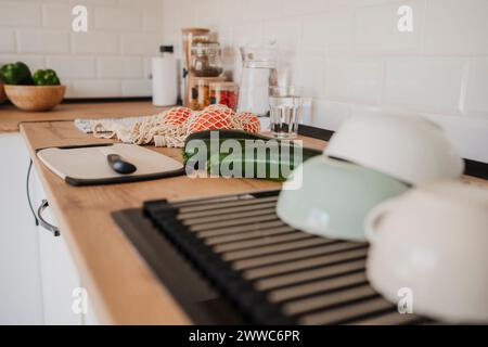 Modern kitchen counter with various food near cutting board and utensils Stock Photo