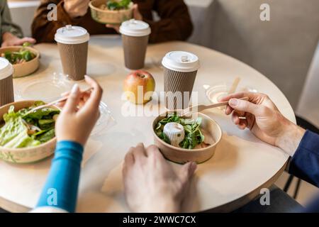 Business colleagues having salad in lunch at office cafe Stock Photo