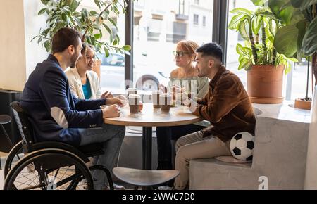 Diverse business colleagues having food at lunch break in office cafe Stock Photo
