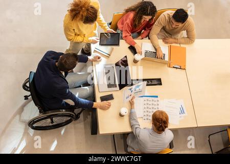 Business colleagues working together at desk in office Stock Photo