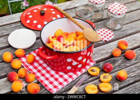 Preparation of apricot jam on wooden garden table Stock Photo