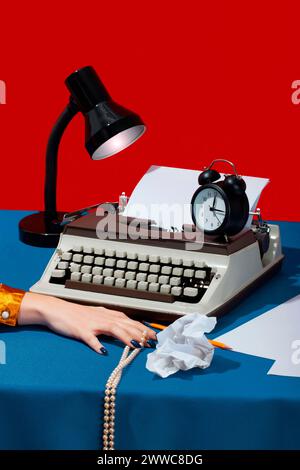 Hand of writer with pearl jewelry near typewriter on desk Stock Photo