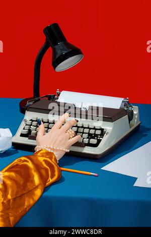 Hand of writer typing on typewriter at desk Stock Photo