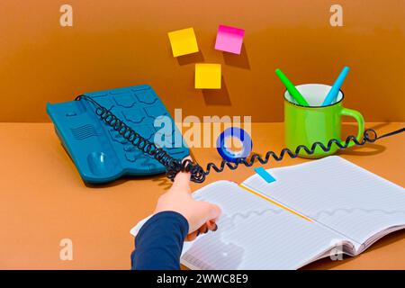 Telephone cable wrapped around finger of saleswoman near book Stock Photo