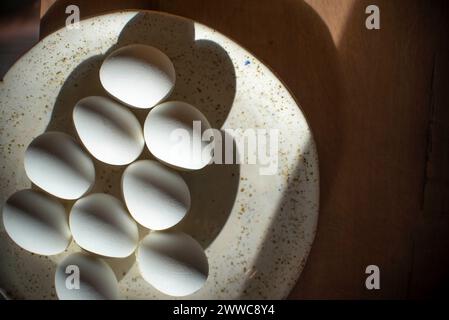 Easter eggs arranged in plate on table at home Stock Photo