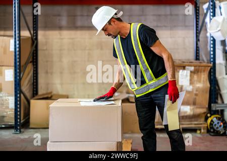 Worker examining checklist at warehouse Stock Photo
