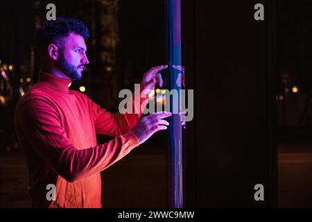 Man using touch screen kiosk at night Stock Photo