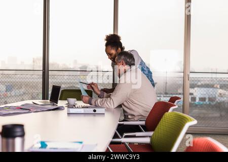 Business colleagues discussing over document in office Stock Photo