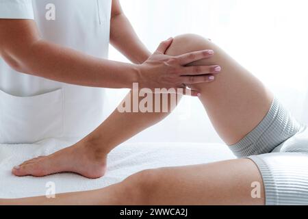 Patient getting physical therapy by osteopath in treatment room Stock Photo