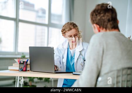 Doctor having discussion with patient at desk in office Stock Photo