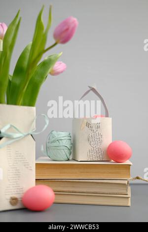 Blooming tulips, books and homemade Easter decorations Stock Photo