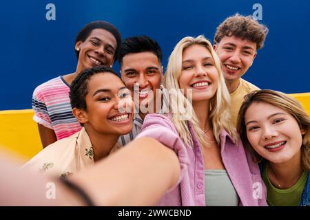 Laughing multi-ethnic friends taking selfie Stock Photo