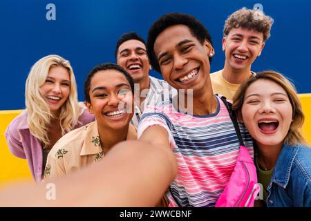 Laughing multi-ethnic friends taking selfie Stock Photo