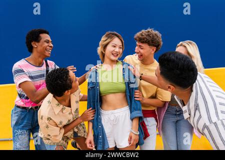 Group of friends are happy for young woman and encouraging her Stock Photo