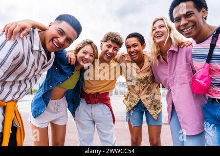 Group photo of happy young friends with colorful clothing smiling at camera Stock Photo