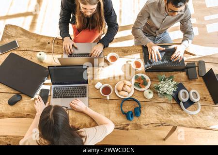 Team of programmers coding on laptops working at creative office Stock Photo