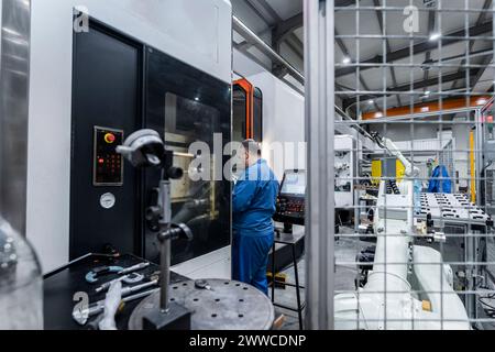 Maintenance engineer working in modern robotics factory Stock Photo