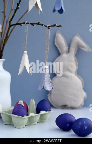 Studio shot of purple Easter eggs and DIY paper craft flowers Stock Photo