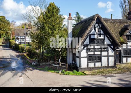 The White Lion a17th century black and white half timbered thatched roofed coaching inn in The Cheshire village of Barthomley Stock Photo