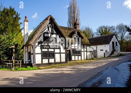 The White Lion a17th century black and white half timbered thatched roofed coaching inn in The Cheshire village of Barthomley Stock Photo