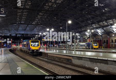 Northern Rail CAF class 331 electric multiple unit train at Liverpool Lime Street railway station at night Stock Photo