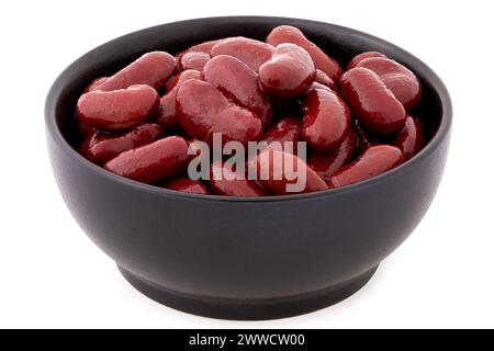 Cooked red kidney beans in a black ceramic bowl isolated on white. Stock Photo