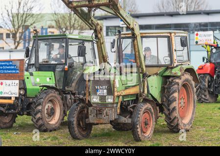 Kaiserslautern, Germany. 23rd March, 2024. Farmers sitting in tractors during protest rally. The protest starts with a rally at Messeplatz (Square) and continues with a convoy drive through the city.  Participants from different industries are welcome to join the demonstration against the current government. Credit: Gustav Zygmund/Alamy News Stock Photo