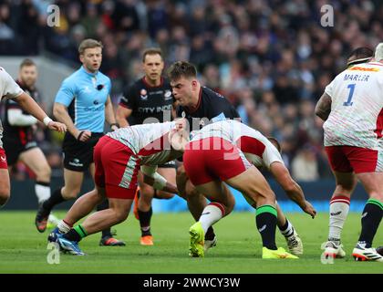 Saracens' Theo Dan is tackled by Harlequins' Lucas Schmid during the ...