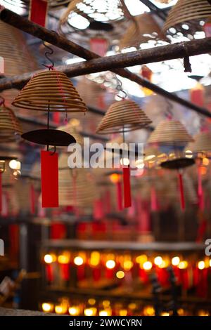 Incense coils of varying sizes hang from the ceiling in Man Mo Temple. Stock Photo