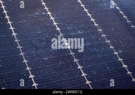 Close up view of damaged broken solar panel tempered glass cell. Stone dent in the middle with spiderweb cracks around. Stock Photo