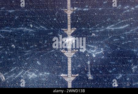 Close up view of damaged broken solar panel tempered glass cell. Stone dent in the middle with spiderweb cracks around. Stock Photo