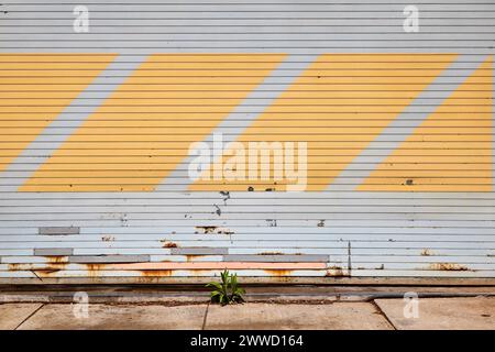 Horizontal View of Closed Grey Garage Door with Yellow Diagonal Stripes Stock Photo