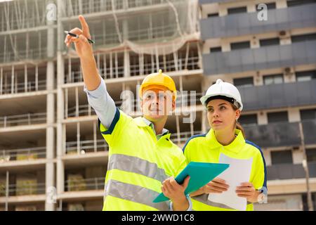 Two qualified engineers are discussing a construction plan Stock Photo