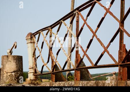 Rusty and Bent Railing on a Bridge Stock Photo