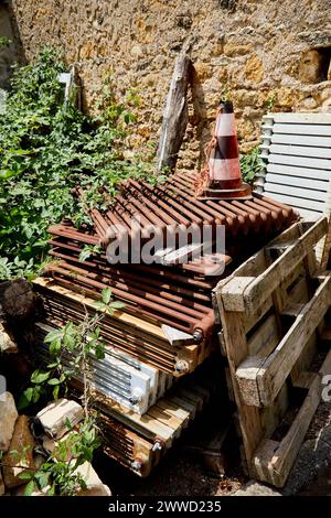 Rusty, Used Radiators Stacked Against Stone Wall Stock Photo