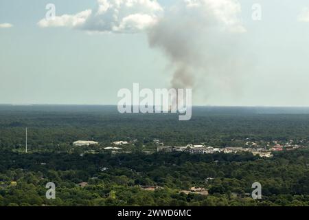 Aerial view of large wildfire burning severely in Florida jungle woods. Hot flames with dense smoke in tropical forest Stock Photo