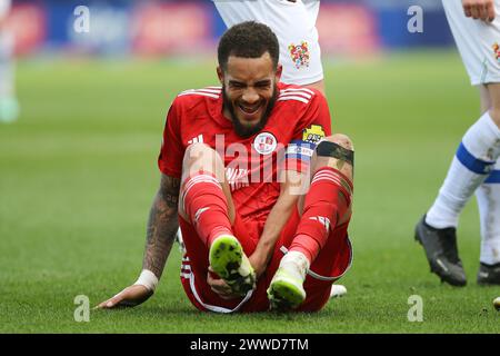 Birkenhead, UK. 23rd Mar, 2024. Jay Williams of Crawley Town holds his injured ankle. EFL Skybet Football league two match, Tranmere Rovers v Crawley Town at Prenton Park, Birkenhead, Wirral on Saturday 23rd March 2024. this image may only be used for Editorial purposes. Editorial use only, .pic by Chris Stading/ Credit: Andrew Orchard sports photography/Alamy Live News Stock Photo